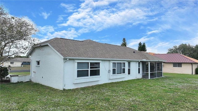 back of house featuring a sunroom and a yard