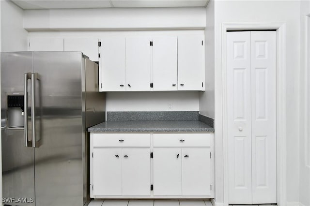 kitchen with white cabinetry and stainless steel fridge