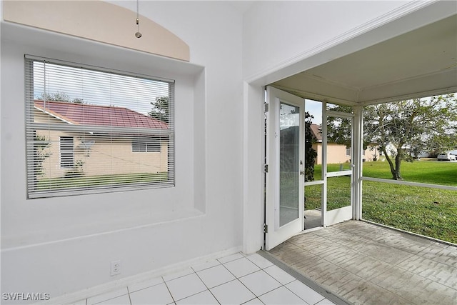 doorway to outside with light tile patterned floors