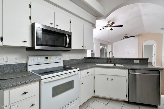 kitchen with appliances with stainless steel finishes, ceiling fan, sink, white cabinets, and light tile patterned flooring