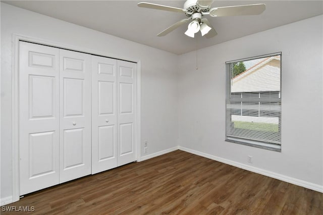 unfurnished bedroom featuring ceiling fan, a closet, and dark hardwood / wood-style floors