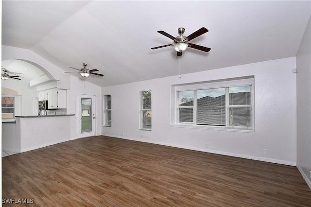 unfurnished living room with dark hardwood / wood-style floors, ceiling fan, and vaulted ceiling