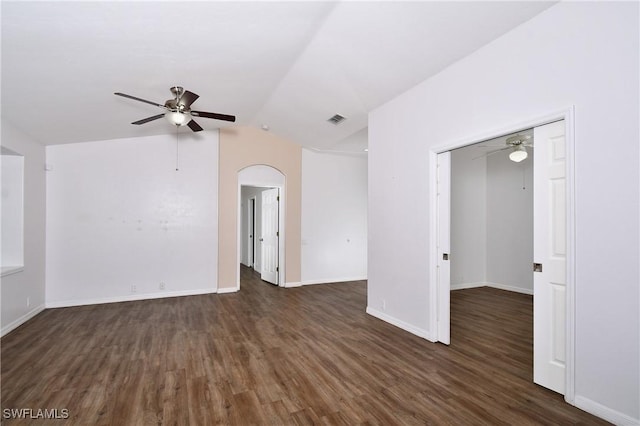 spare room with ceiling fan, lofted ceiling, and dark wood-type flooring