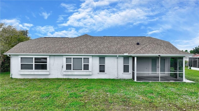 back of house featuring a yard and a sunroom