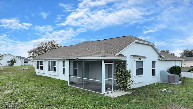 back of property featuring a sunroom, a yard, and cooling unit