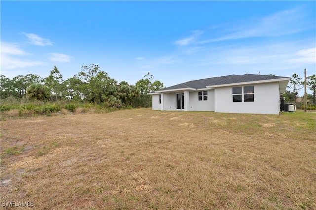 rear view of property with a yard