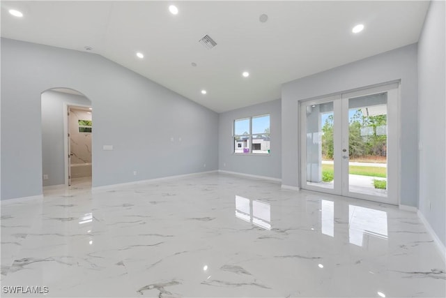 unfurnished room with french doors and lofted ceiling