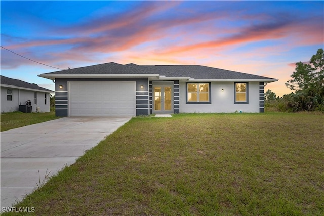 view of front of property with a garage, driveway, and a front lawn