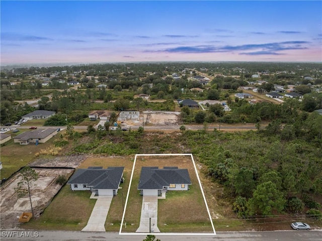 aerial view at dusk featuring a residential view