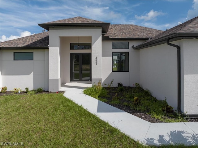 property entrance with french doors and a yard