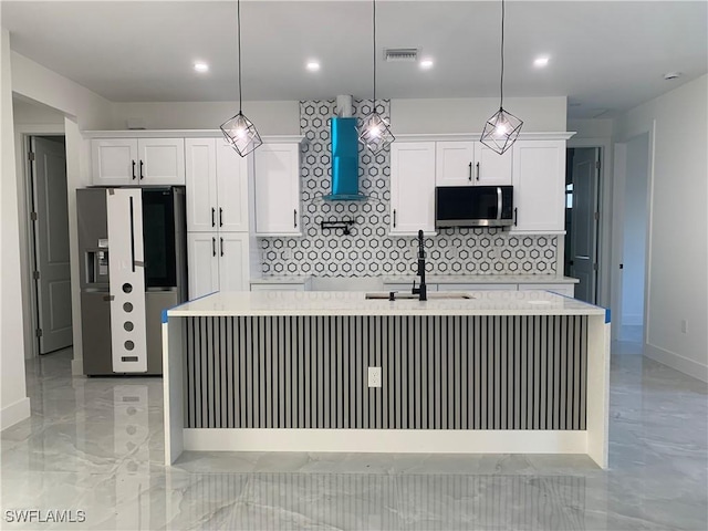 kitchen featuring white cabinets, sink, stainless steel appliances, and hanging light fixtures