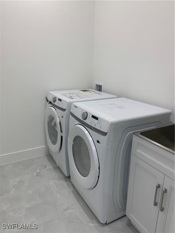 laundry room featuring cabinets and separate washer and dryer