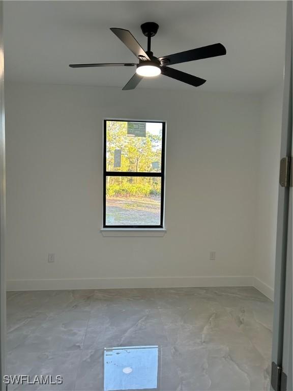 unfurnished room with ceiling fan