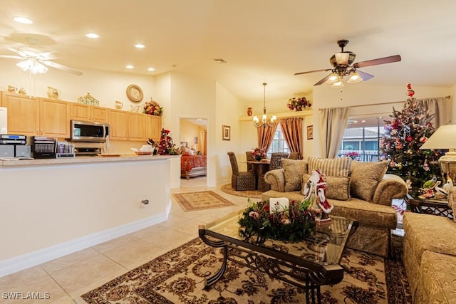 tiled living room featuring ceiling fan with notable chandelier and high vaulted ceiling