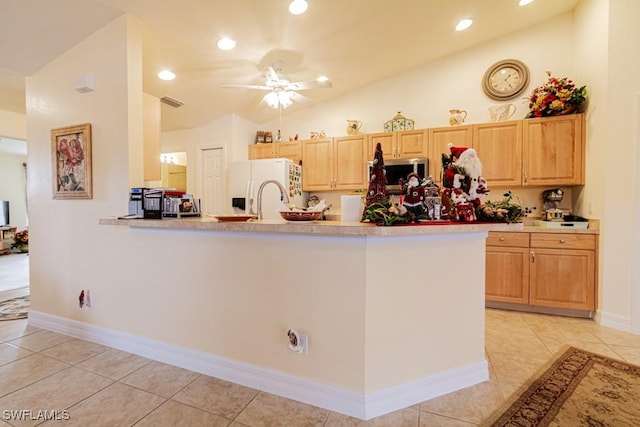 kitchen with white fridge with ice dispenser, light brown cabinetry, light tile patterned floors, and vaulted ceiling