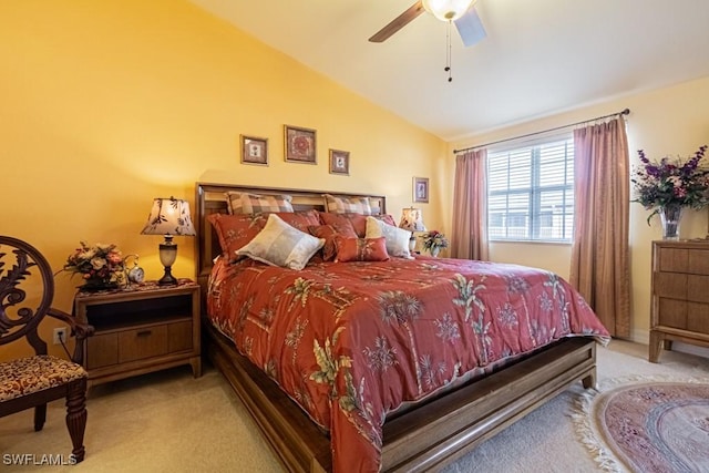 carpeted bedroom with ceiling fan and vaulted ceiling