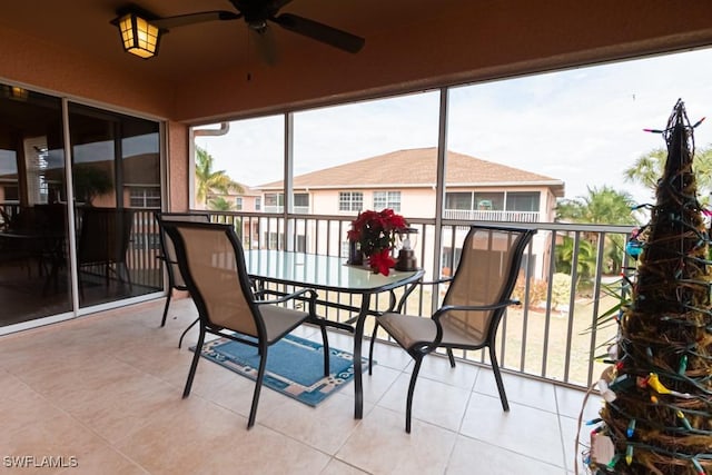 sunroom / solarium featuring ceiling fan