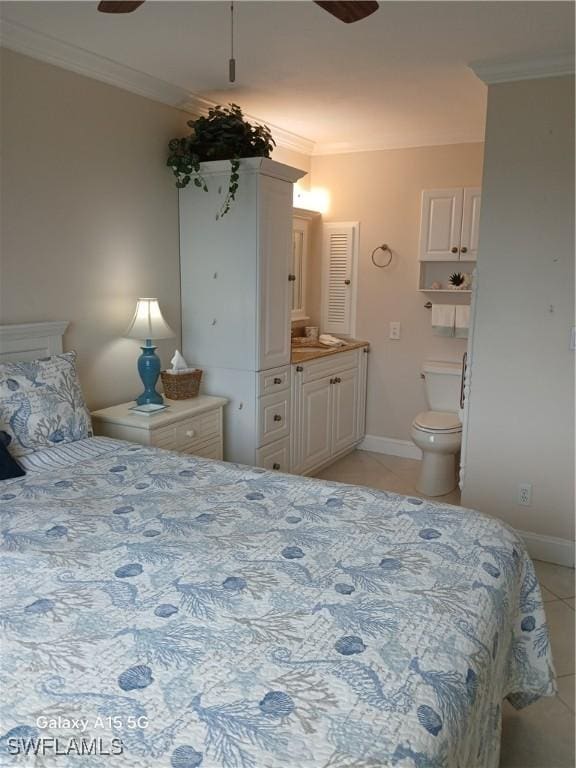 bedroom with ensuite bath, crown molding, light tile patterned floors, and ceiling fan