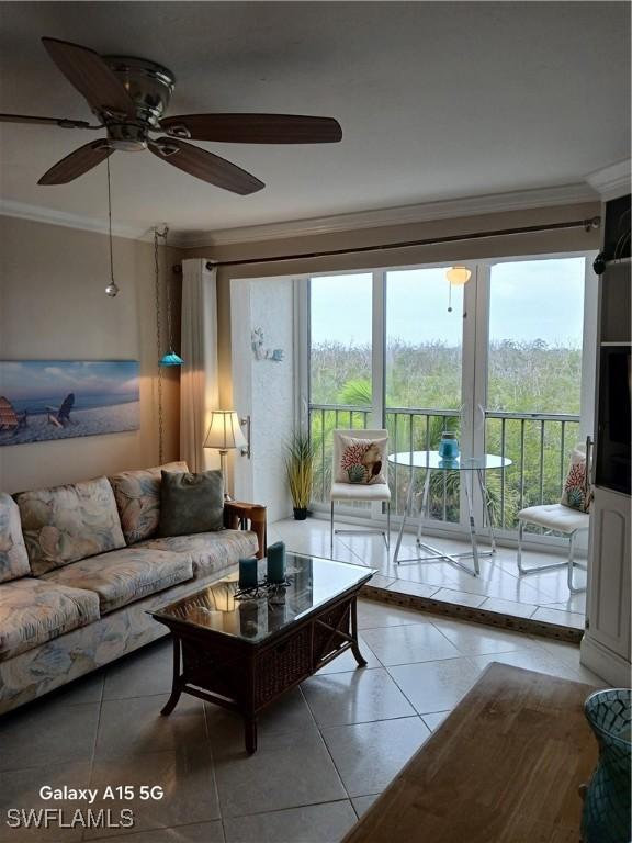 tiled living room with french doors, ceiling fan, and crown molding