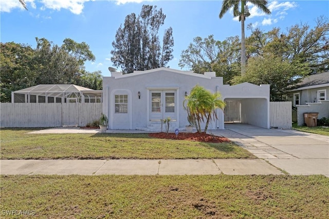 view of front of home featuring a front lawn and a carport