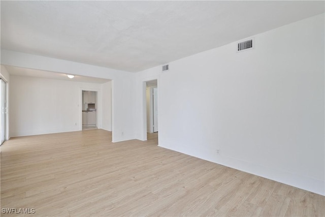 unfurnished room with light hardwood / wood-style floors