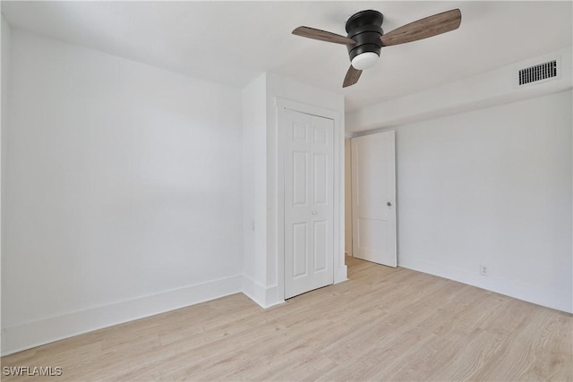 unfurnished bedroom featuring ceiling fan, a closet, and light hardwood / wood-style flooring