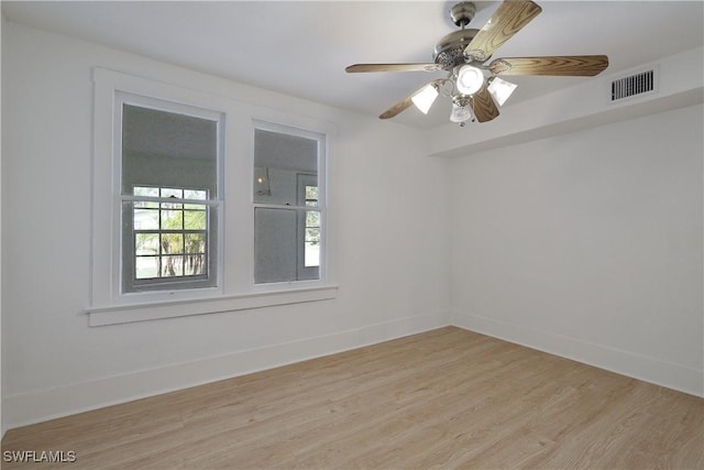 empty room with ceiling fan and light hardwood / wood-style floors