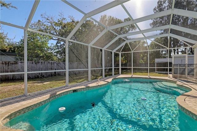 view of pool featuring a patio and glass enclosure