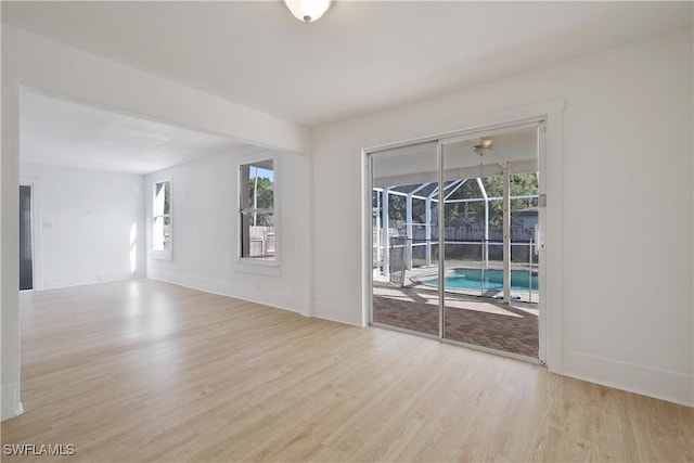 spare room featuring light wood-type flooring and a wealth of natural light