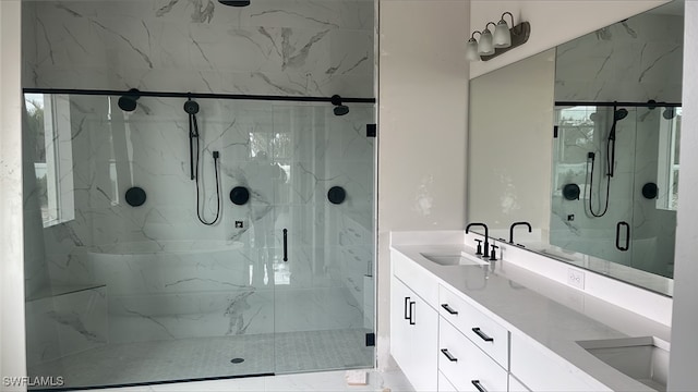 bathroom with vanity and a shower with door