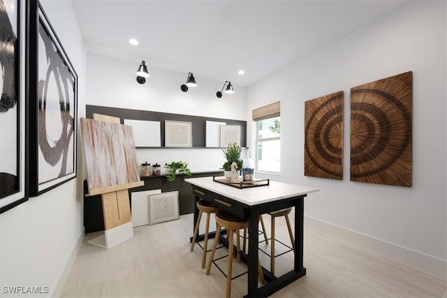 dining space featuring recessed lighting, baseboards, and light wood-type flooring