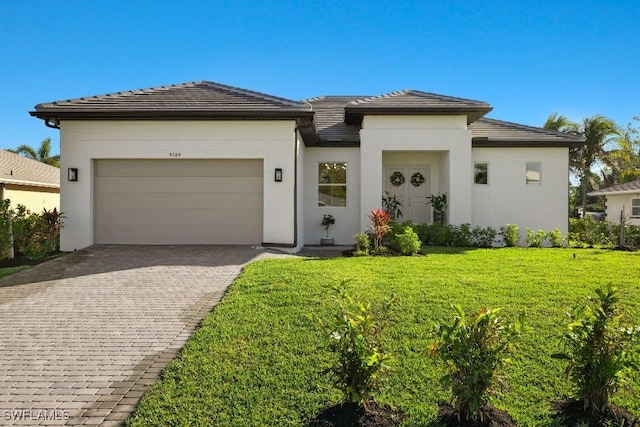 4584 W Alhambra Cir, Naples, FL 34103 - prairie-style home featuring a front yard and a garage