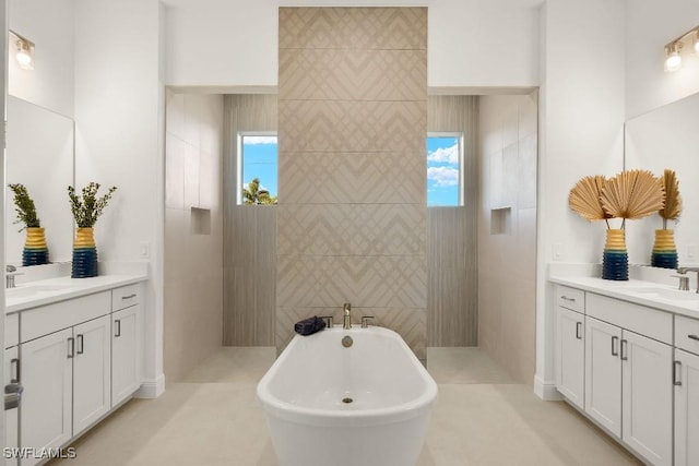 4584 W Alhambra Cir, Naples, FL 34103 - bathroom featuring vanity, a tub to relax in, and tile walls