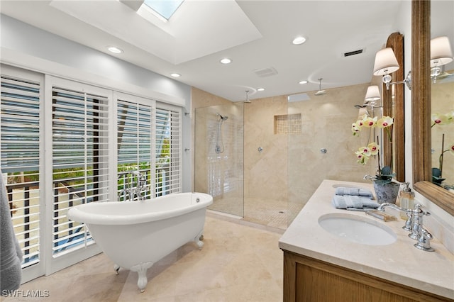 bathroom with vanity, independent shower and bath, and a skylight