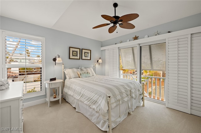 carpeted bedroom featuring ceiling fan, access to exterior, and lofted ceiling