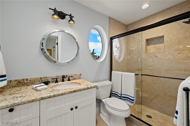 bathroom with vanity, toilet, and walk in shower