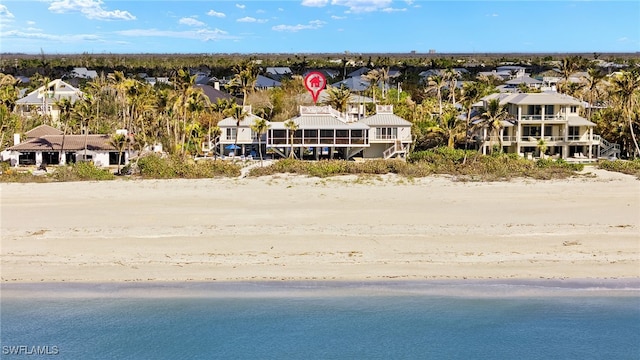 birds eye view of property featuring a water view and a view of the beach