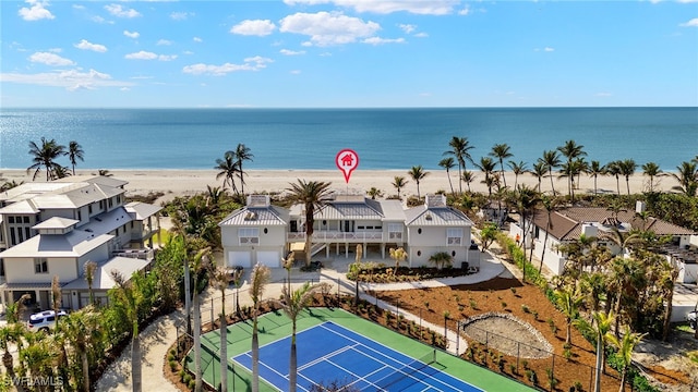 birds eye view of property with a view of the beach and a water view