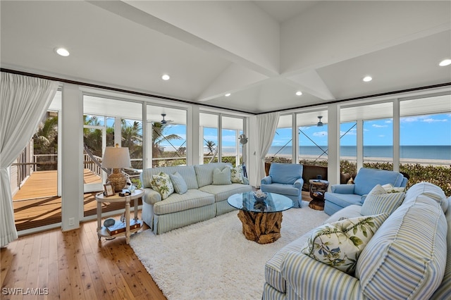 living room featuring wood-type flooring, a water view, and ceiling fan