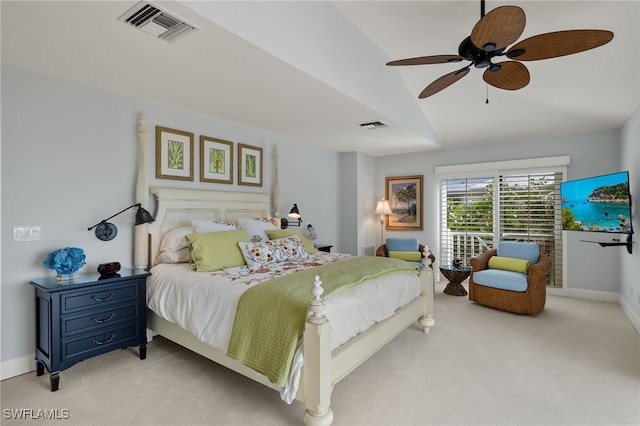 bedroom featuring light colored carpet, vaulted ceiling, and ceiling fan