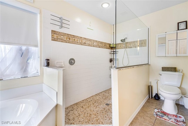 full bathroom with tile patterned flooring, shower with separate bathtub, sink, and toilet