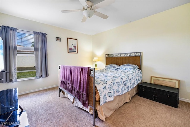 bedroom featuring ceiling fan and light carpet