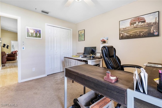 carpeted office featuring ceiling fan