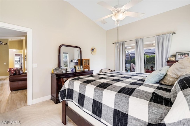 bedroom featuring high vaulted ceiling, light colored carpet, and ceiling fan