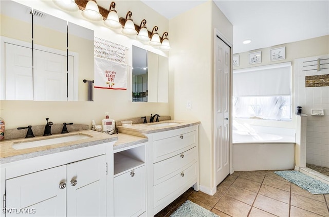 bathroom featuring vanity, a bathing tub, and tile patterned flooring