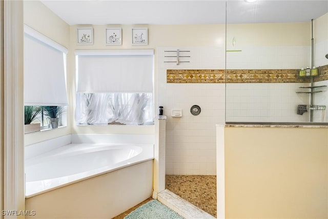 bathroom featuring separate shower and tub