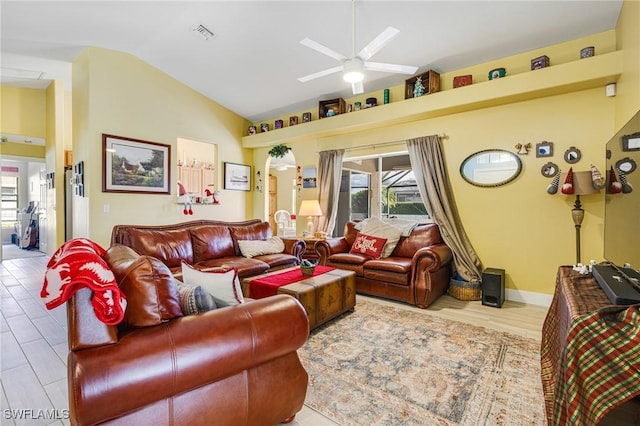 living room with ceiling fan and lofted ceiling