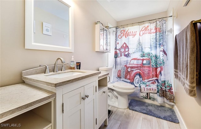 bathroom featuring vanity, hardwood / wood-style flooring, toilet, and walk in shower