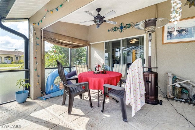 sunroom featuring ceiling fan