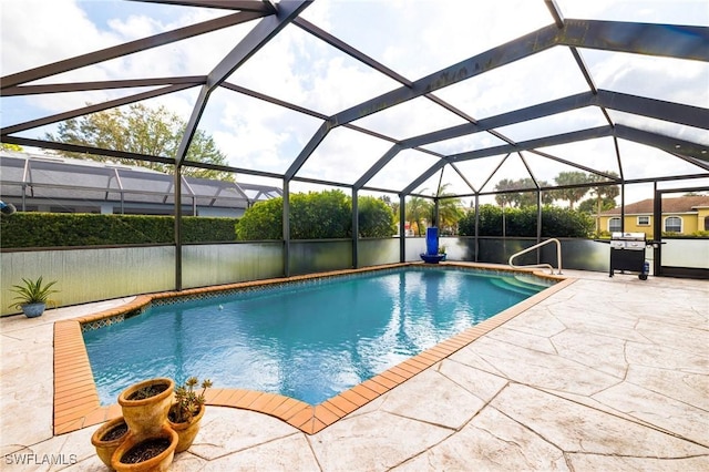 view of swimming pool featuring a lanai, grilling area, and a patio area